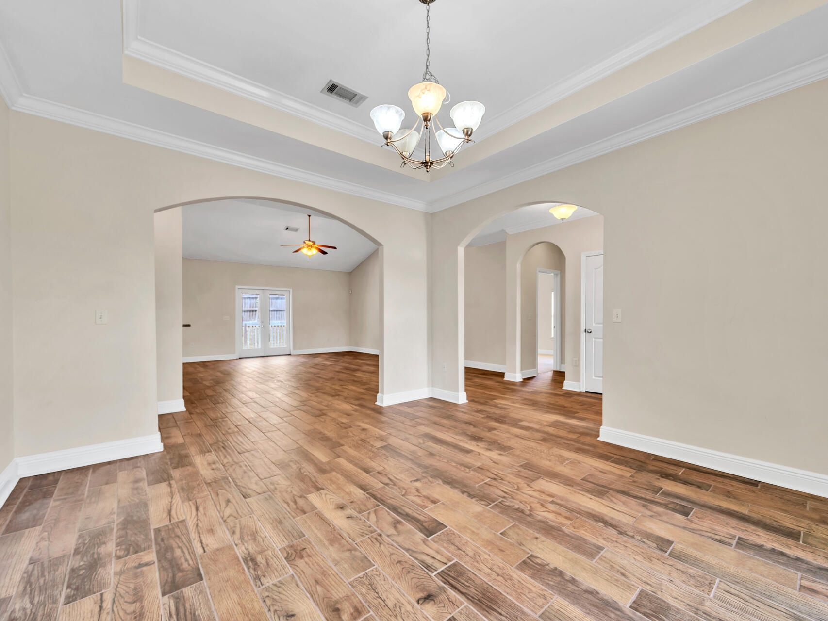 612 Rowan Circle Crestview, FL 32536 - Photo 6 of 32 a view of an empty room with window and wooden floor