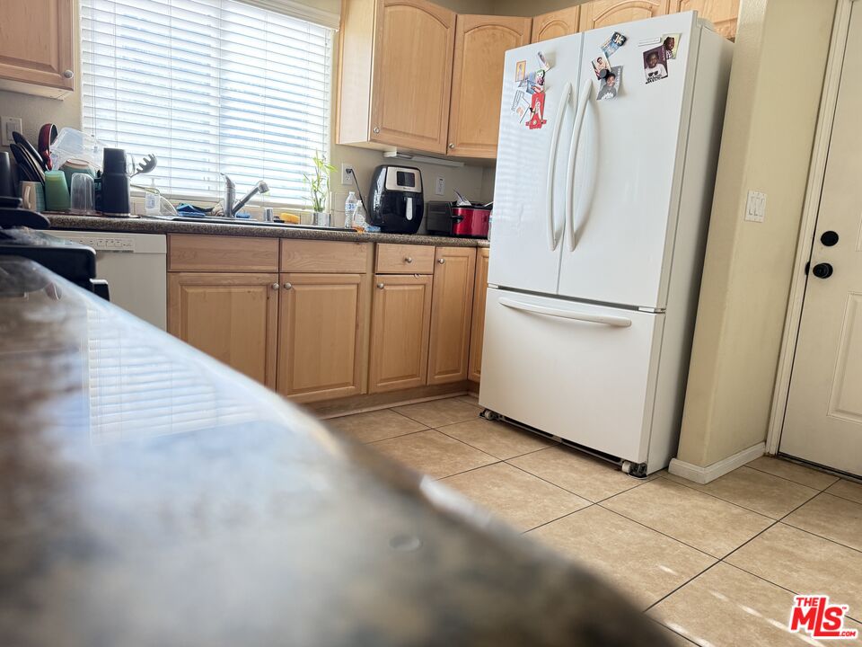 18238 Kalin Ranch Drive Victorville, CA 92395 - Photo 13 of 33 a white refrigerator freezer sitting in a kitchen