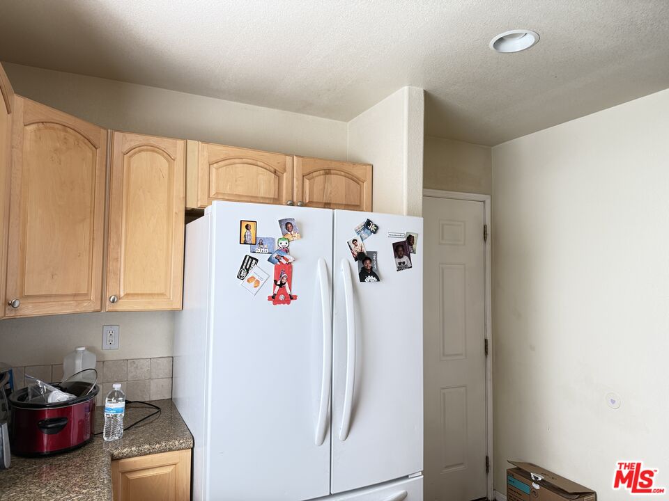18238 Kalin Ranch Drive Victorville, CA 92395 - Photo 14 of 33 a white refrigerator freezer sitting in a kitchen