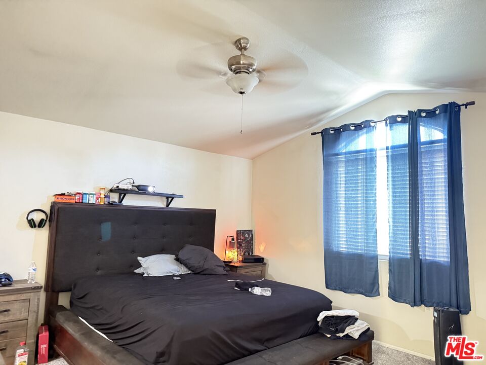 18238 Kalin Ranch Drive Victorville, CA 92395 - Photo 27 of 33 a bedroom with a bed and window