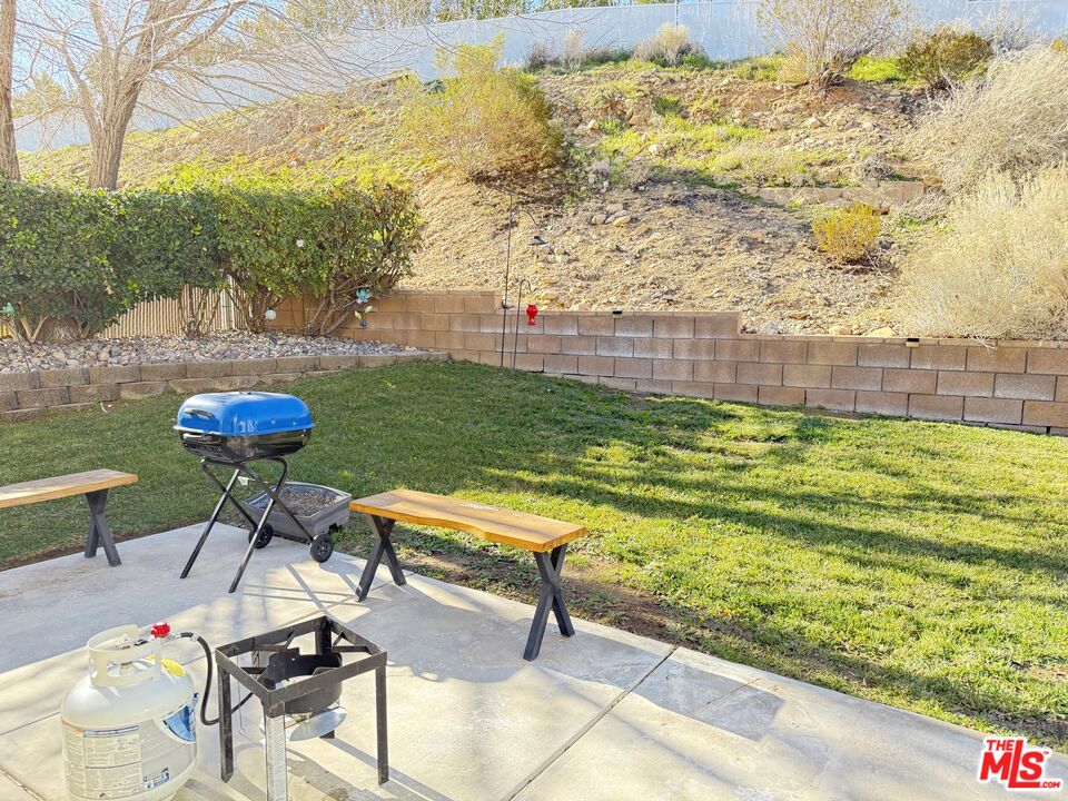 18238 Kalin Ranch Drive Victorville, CA 92395 - Photo 33 of 33 a view of a backyard with plants and outdoor seating