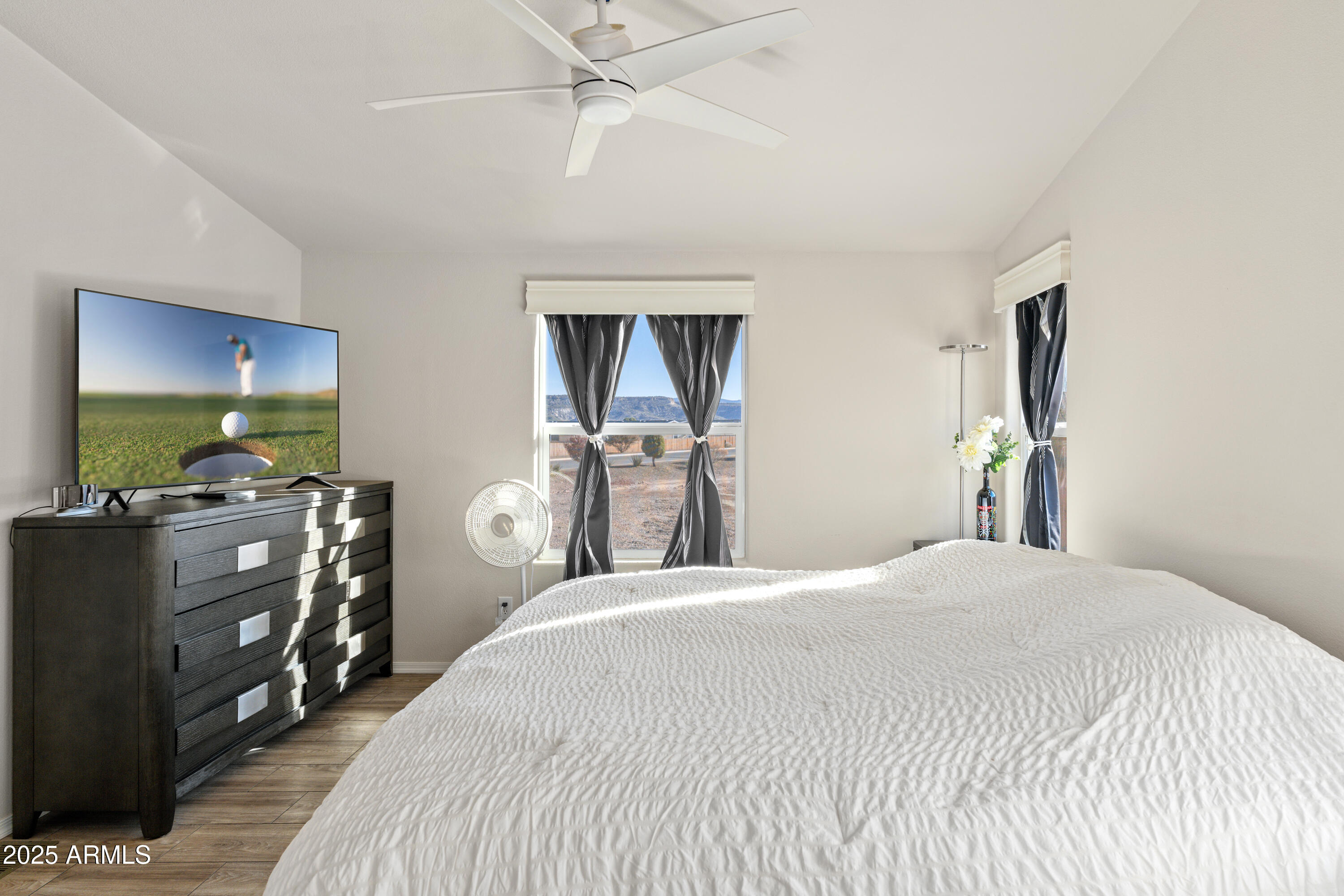 1033 Wheeler Road Camp Verde, AZ 86322 - Photo 16 of 51 a bedroom with a bed and a chandelier
