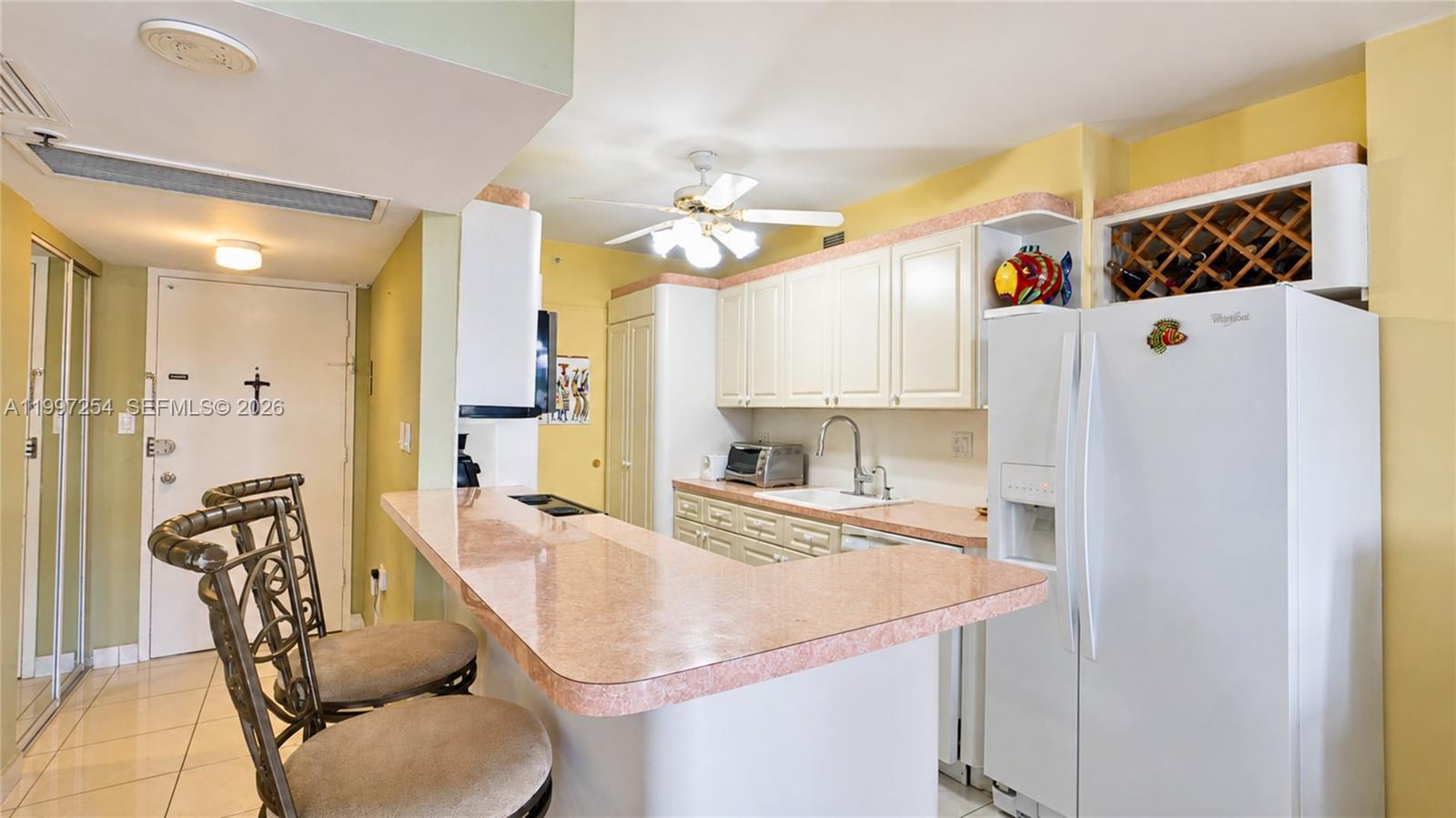 100 Lincoln Road, Unit 422 Miami Beach, FL 33139 - Photo 3 of 23 a kitchen with a table chairs refrigerator and a sink