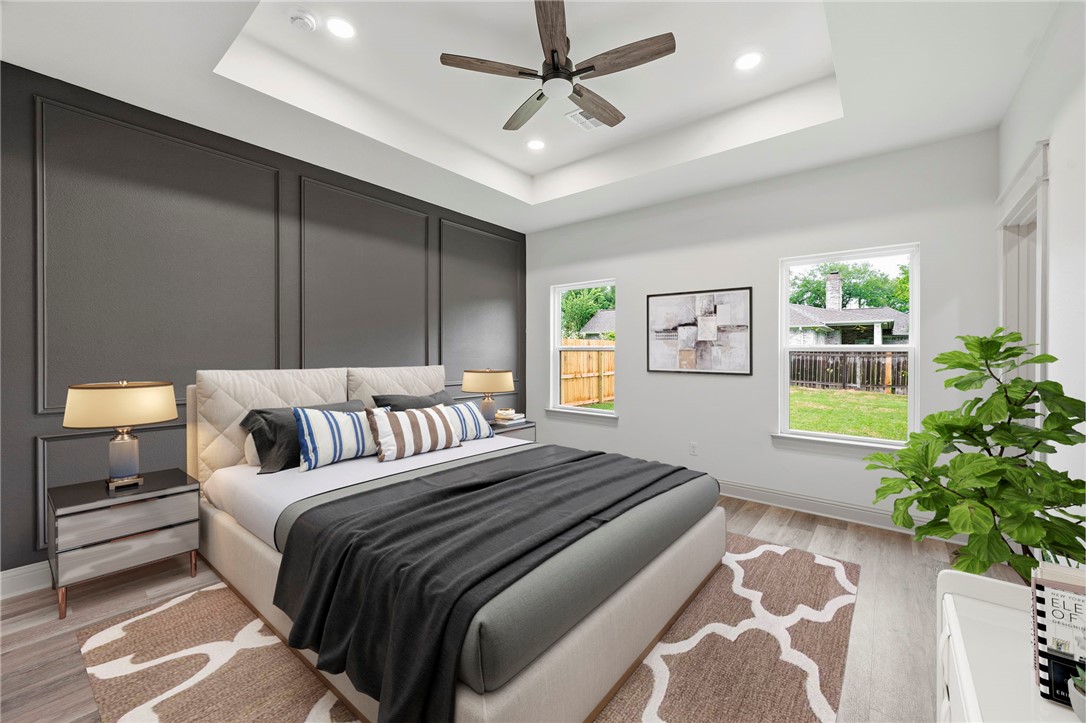 505 Legion Court Bryan, TX 77803 - Photo 8 of 21 a bedroom with a large bed and a potted plant