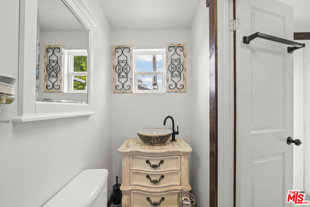 5732 6th Avenue Los Angeles, CA 90043 - Photo 14 of 22 a bathroom with a toilet a sink and a window