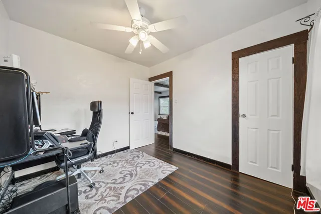 a view of a workspace with furniture and wooden floor