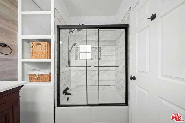 a bathroom with a glass shower door