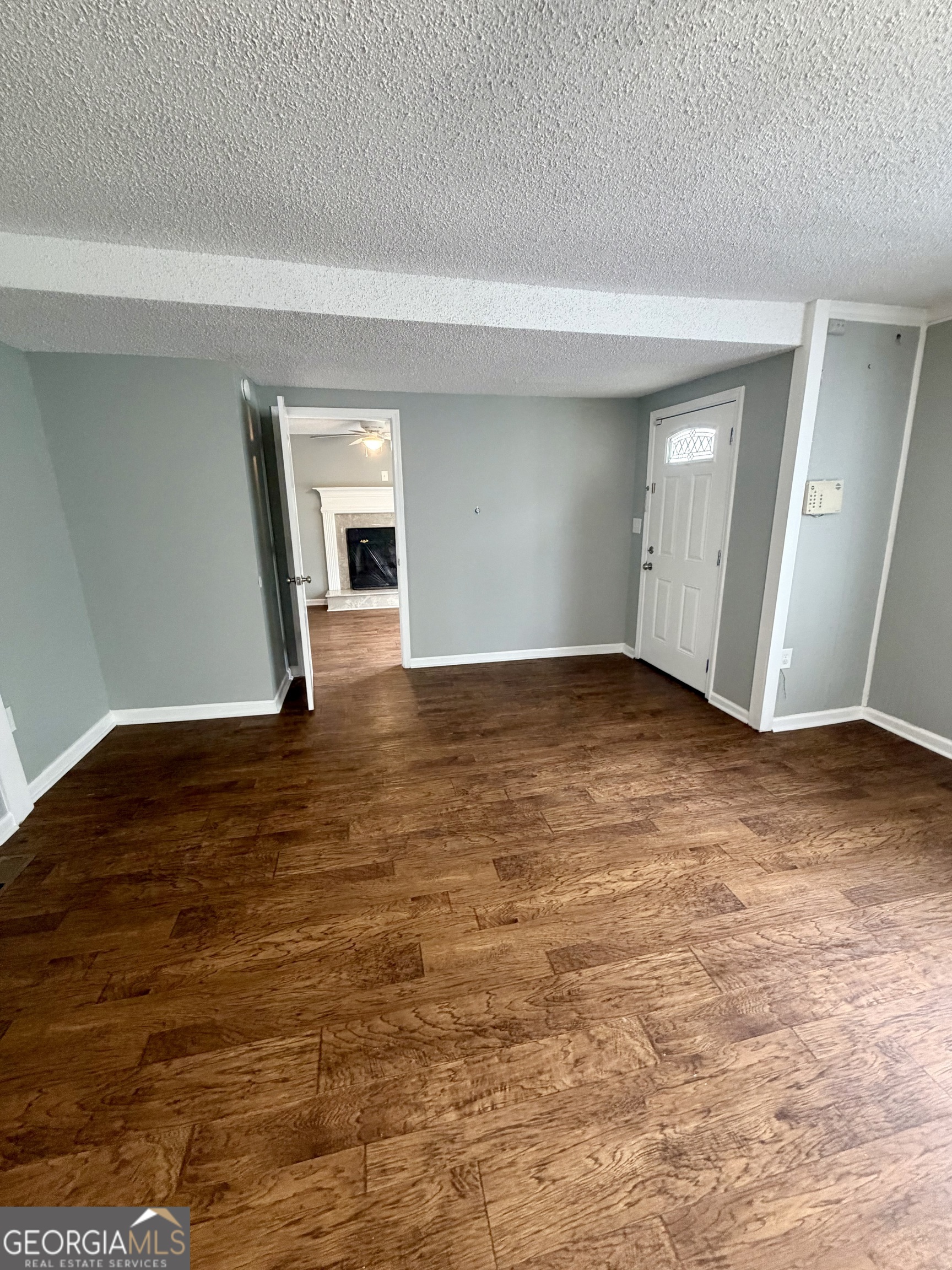 666 Woolfolk Street Macon, GA 31217 - Photo 11 of 60 a view of an empty room with window and wooden floor