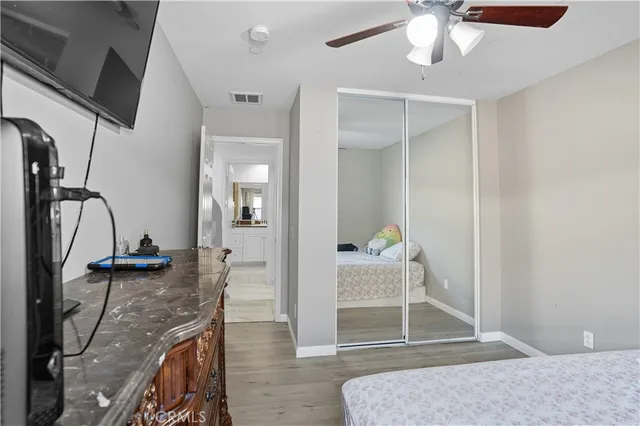 a bathroom with a granite countertop sink and a toilet