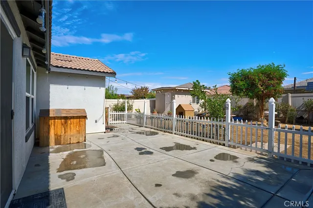a view of a patio with a table and chairs and potted plants