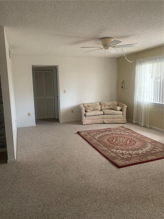 500 Newell Hill Road, Unit 104C Leesburg, FL 34748 - Photo 14 of 15 a living room with furniture and a rug