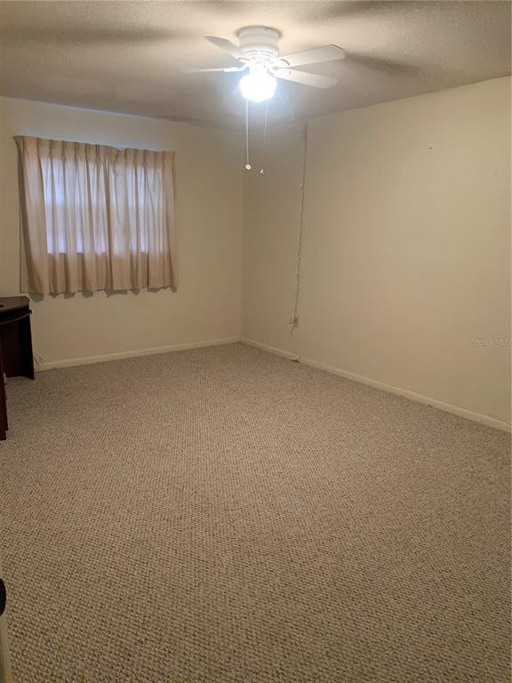 500 Newell Hill Road, Unit 104C Leesburg, FL 34748 - Photo 8 of 15 an empty room with a empty space and windows