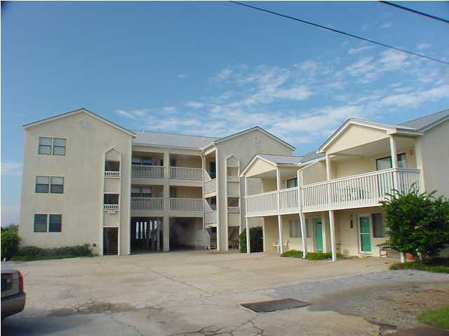 6015 Highway Santa Rosa Beach, Unit A201 30A Santa Rosa Beach, FL 32459 - Photo 21 of 24 a front view of a building with a garden