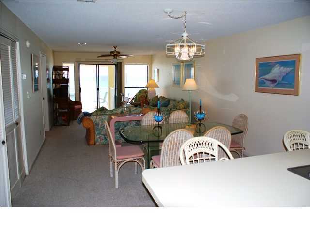 6015 Highway Santa Rosa Beach, Unit A201 30A Santa Rosa Beach, FL 32459 - Photo 5 of 24 a living room with furniture a chandelier and a dining table