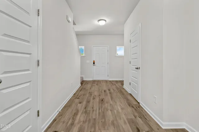 a view of a hallway with wooden floor