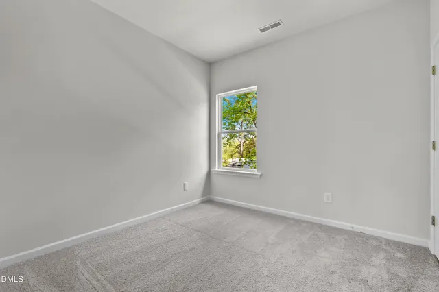 a bathroom with a granite countertop toilet a sink and a mirror