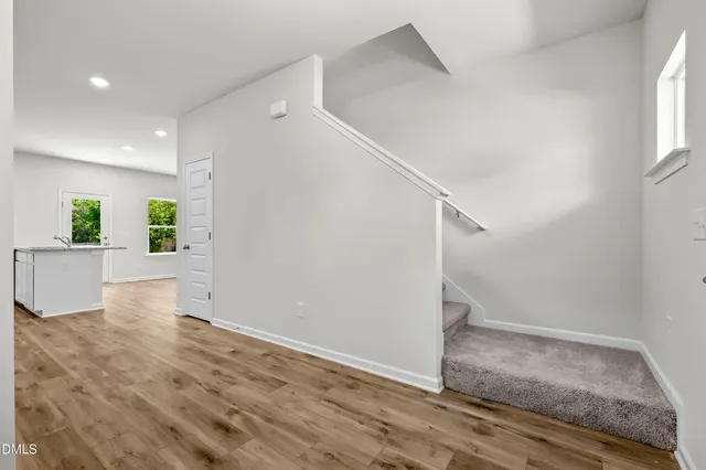 a view of a hallway view with wooden floor and staircase