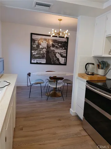 a living room with furniture a flat screen tv and a table