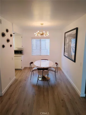 a view of a dining room with furniture and wooden floor
