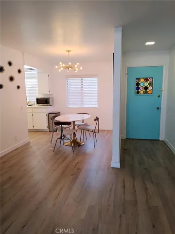 a dining room with furniture and wooden floor