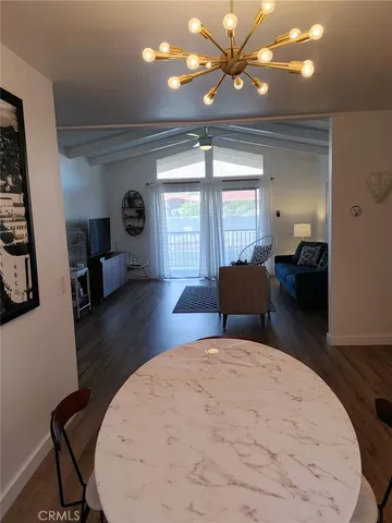 a view of a dining room with furniture wooden floor and a chandelier