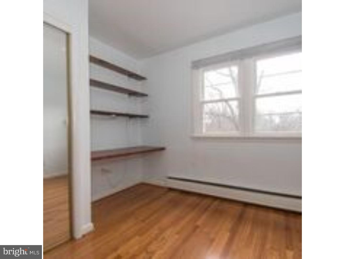 165 Ridgefield Road Newtown Square, PA 19073 - Photo 13 of 19 a view of an empty room with a window and wooden floor