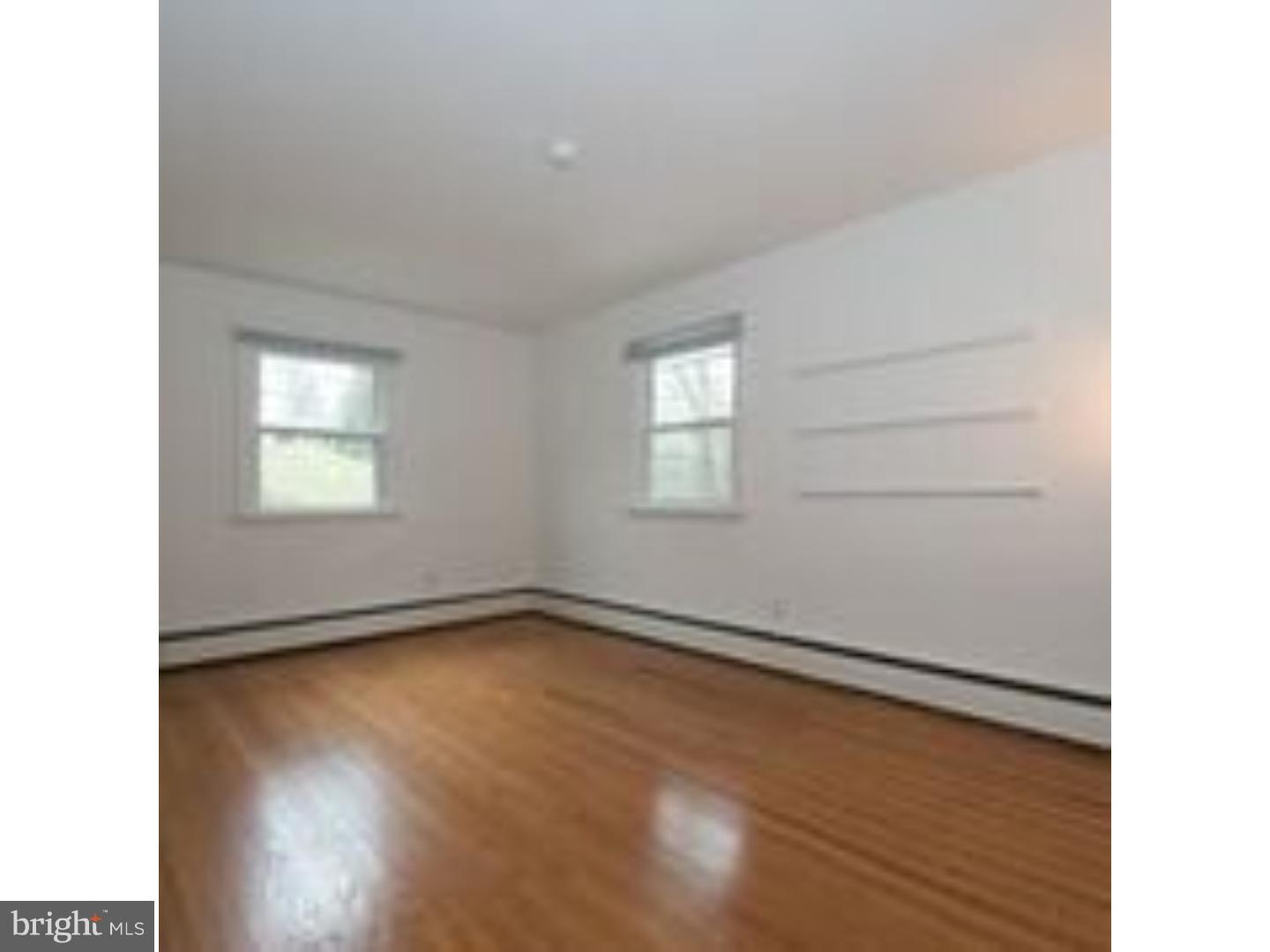 165 Ridgefield Road Newtown Square, PA 19073 - Photo 15 of 19 a view of an empty room with wooden floor and a window