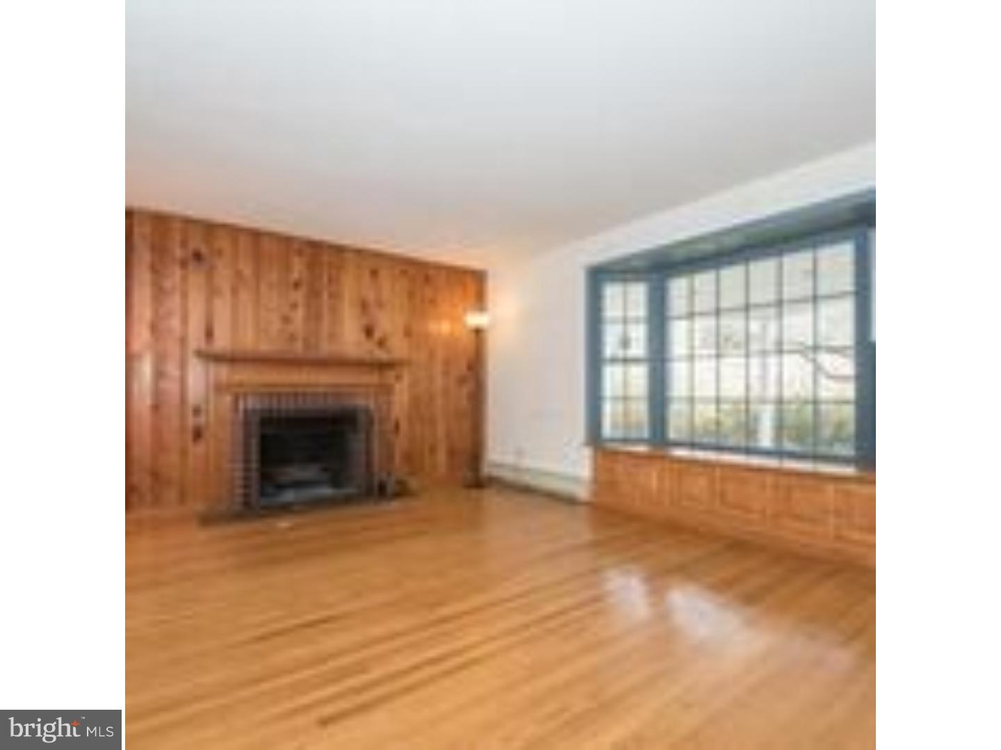 165 Ridgefield Road Newtown Square, PA 19073 - Photo 3 of 19 a view of an empty room with a fireplace and a window