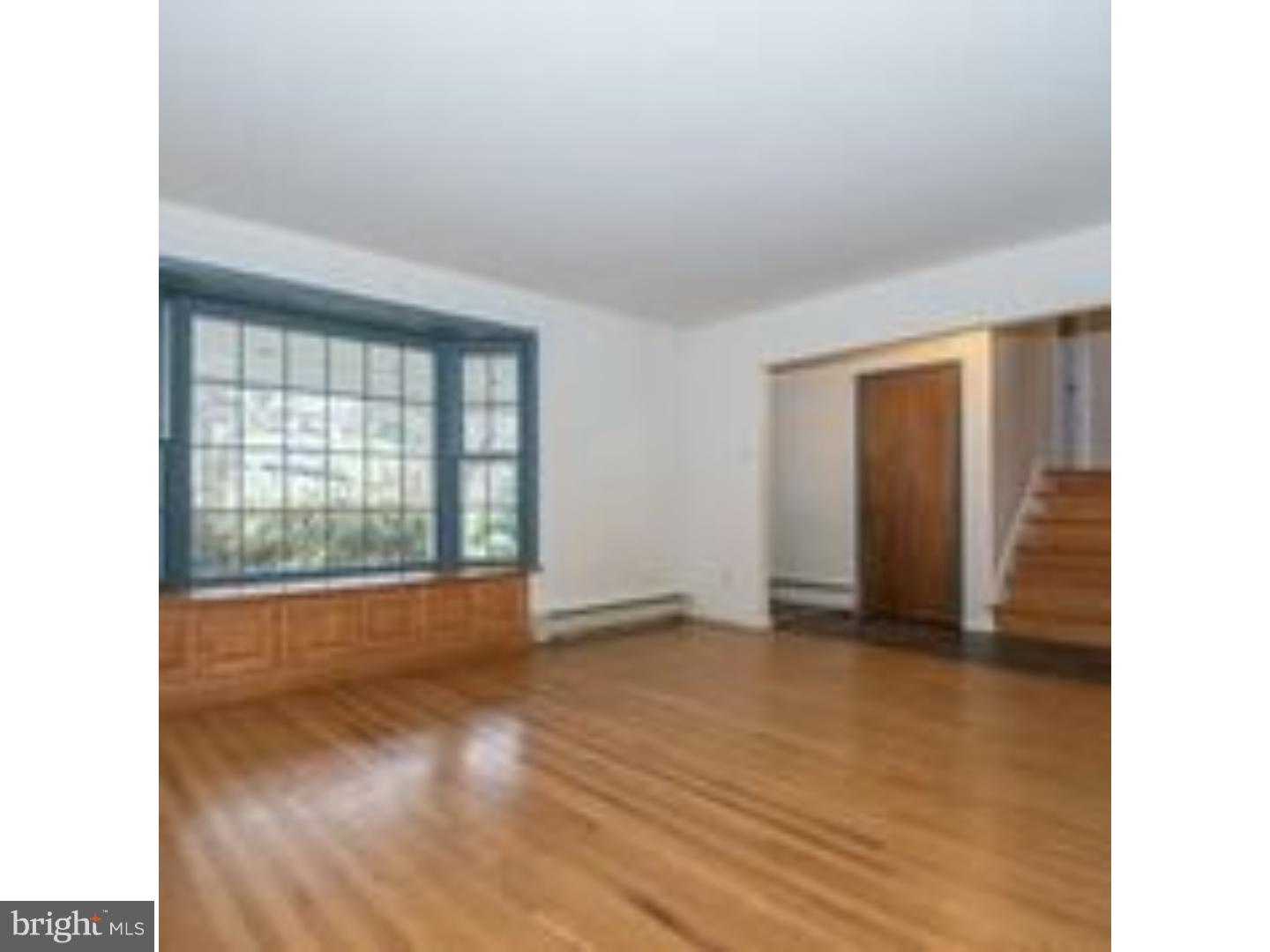 165 Ridgefield Road Newtown Square, PA 19073 - Photo 5 of 19 a view of an empty room with wooden floor and a window