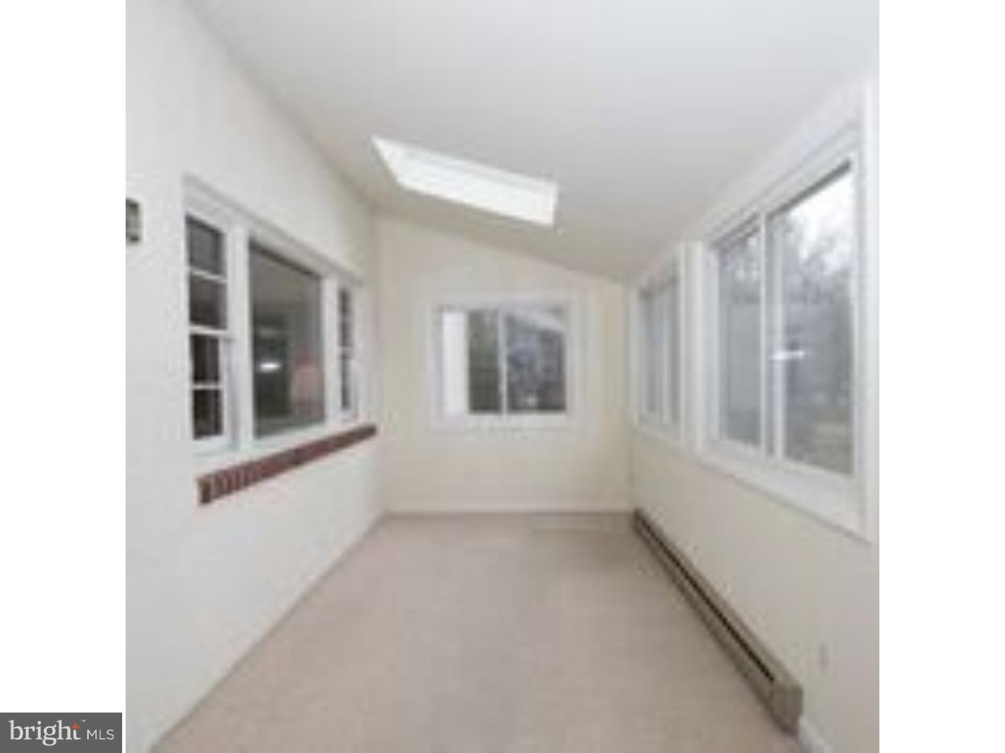 165 Ridgefield Road Newtown Square, PA 19073 - Photo 8 of 19 a view of an empty room with a window