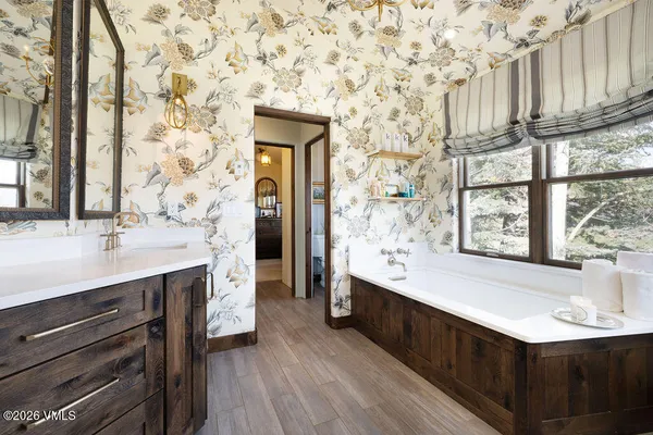 a view of a hallway with furniture and wooden floor