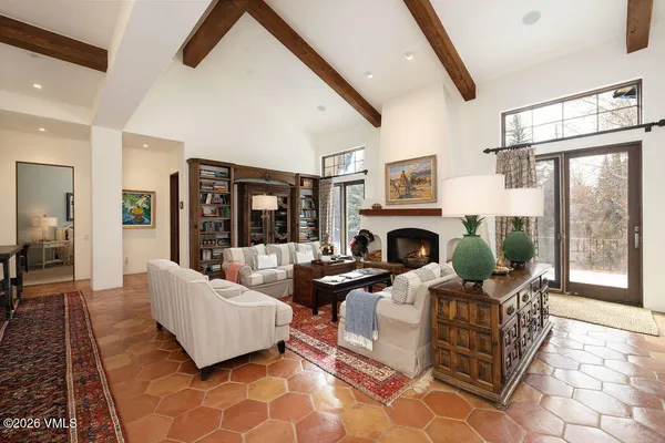a living room with furniture large window and a fireplace