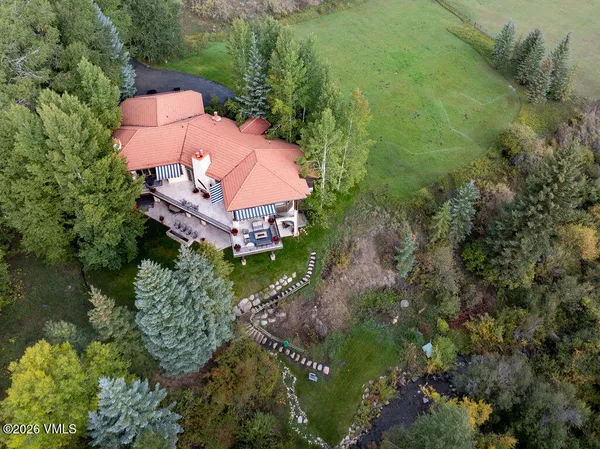 a view of a lush green field with mountains in the background