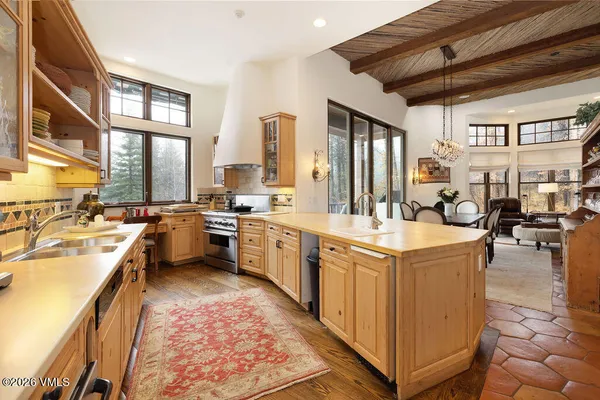 a kitchen with a stove a sink dishwasher and a refrigerator