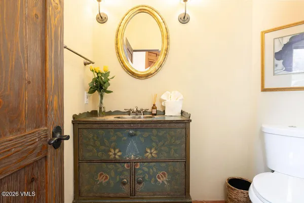 a view of a hallway to a livingroom with furniture