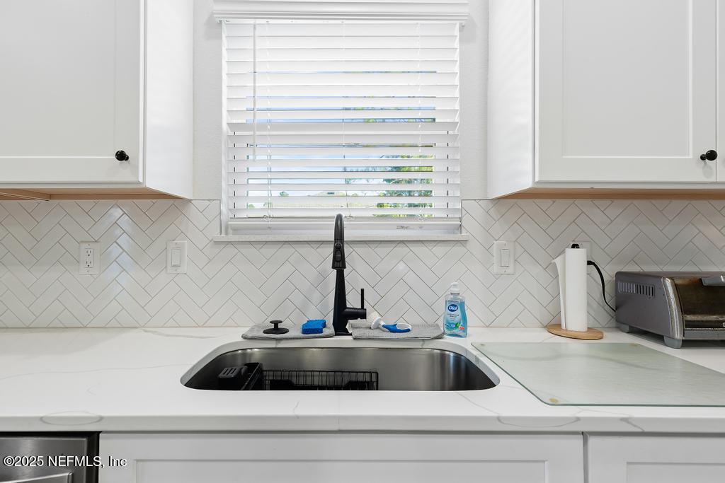 36012 Pitch Lane Hilliard, FL 32046 - Photo 17 of 54 a kitchen with a sink and cabinets