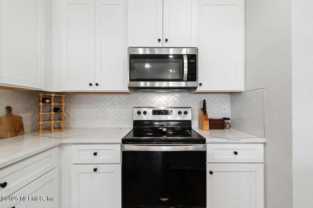 36012 Pitch Lane Hilliard, FL 32046 - Photo 18 of 54 a kitchen with a stove and a microwave