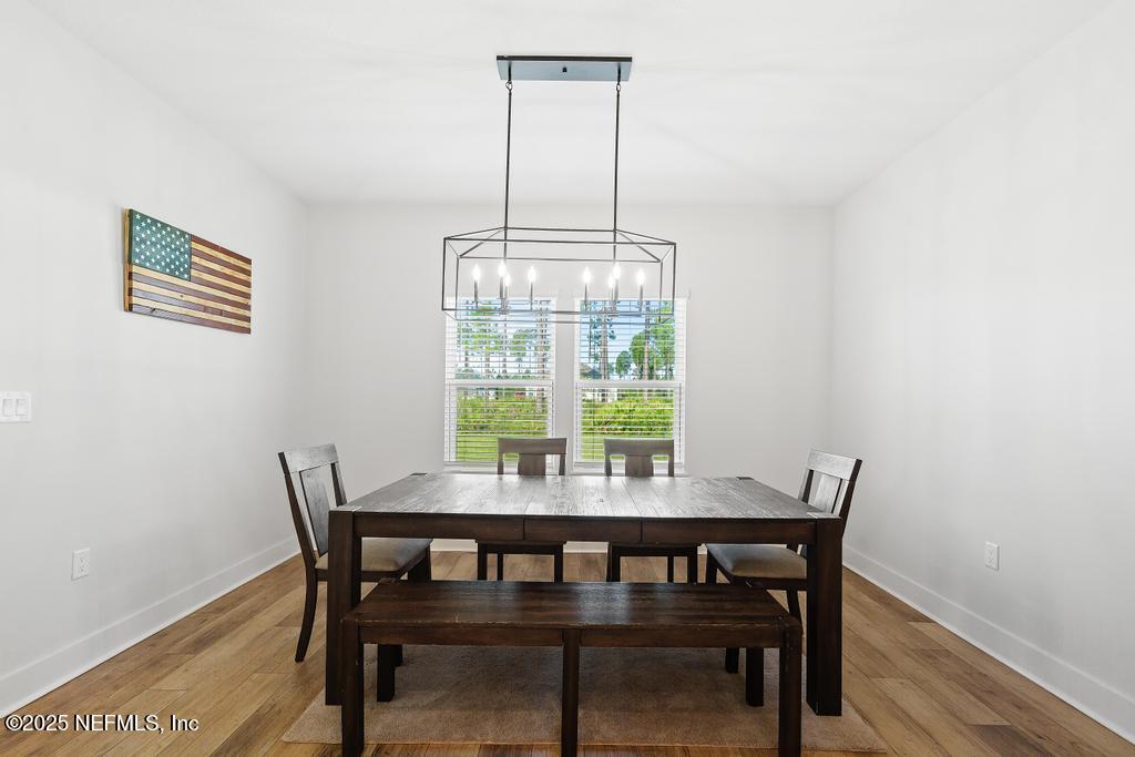 36012 Pitch Lane Hilliard, FL 32046 - Photo 20 of 54 a view of a dining room with furniture window and wooden floor