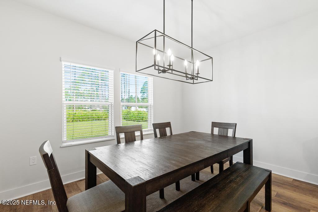36012 Pitch Lane Hilliard, FL 32046 - Photo 21 of 54 a view of a dining room with a table and chairs