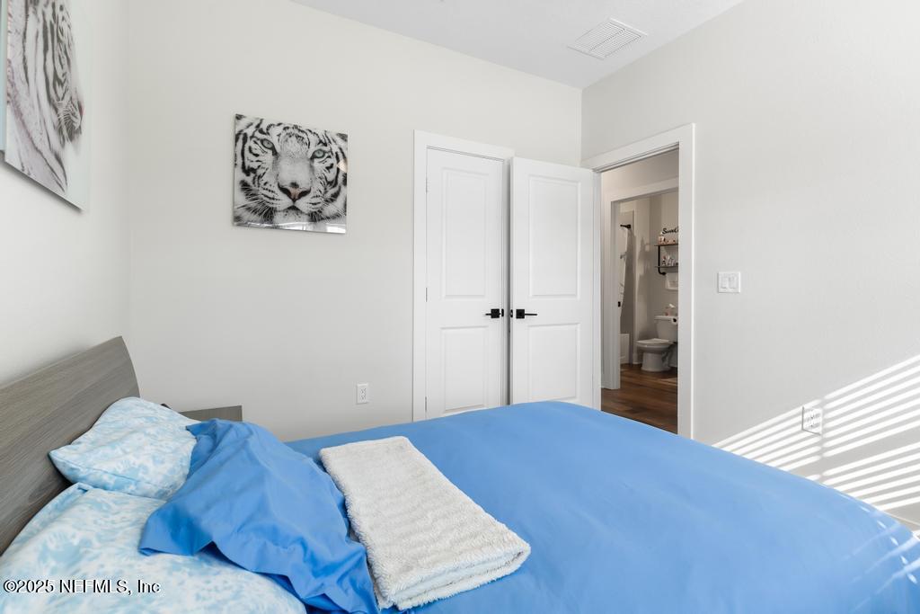 36012 Pitch Lane Hilliard, FL 32046 - Photo 28 of 54 a bedroom with a bed and a window