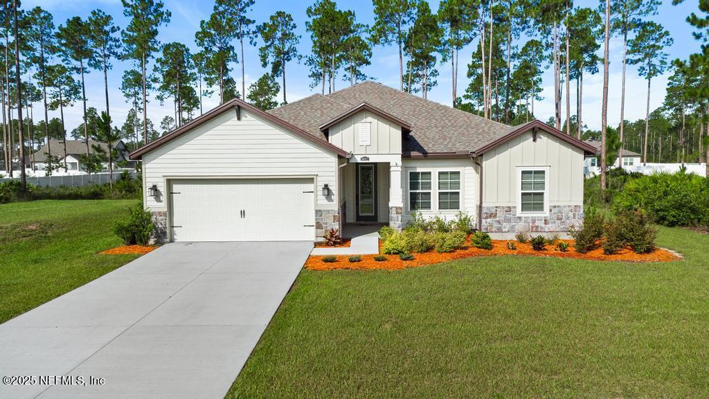36012 Pitch Lane Hilliard, FL 32046 - Photo 3 of 54 a front view of a house with a yard and garage
