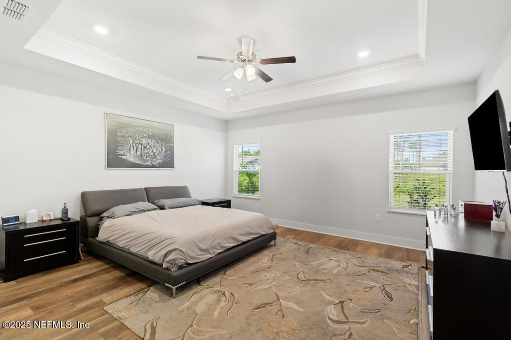 36012 Pitch Lane Hilliard, FL 32046 - Photo 32 of 54 a bedroom with a bed and a flat screen tv