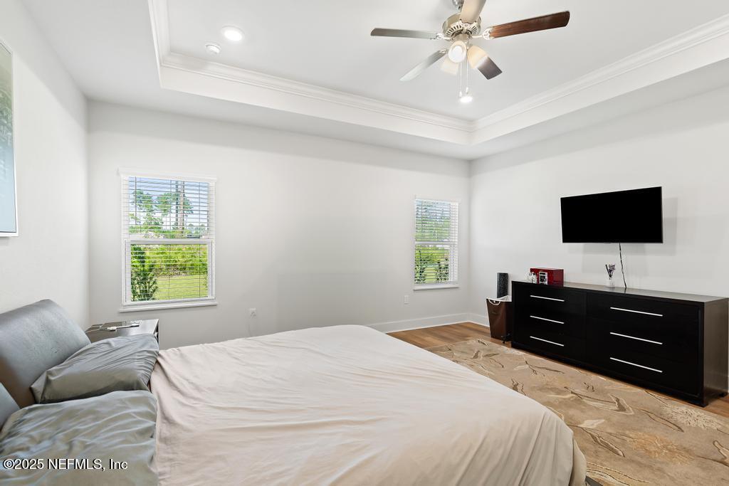 36012 Pitch Lane Hilliard, FL 32046 - Photo 33 of 54 a bedroom with a bed and a flat tv screen on dresser