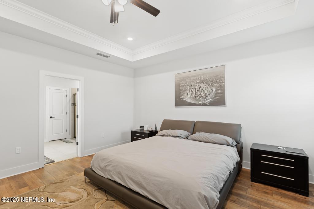 36012 Pitch Lane Hilliard, FL 32046 - Photo 34 of 54 a bedroom with a bed and a chandelier