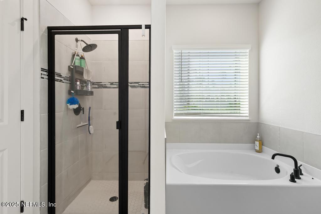 36012 Pitch Lane Hilliard, FL 32046 - Photo 38 of 54 a bathroom with a bathtub and shower
