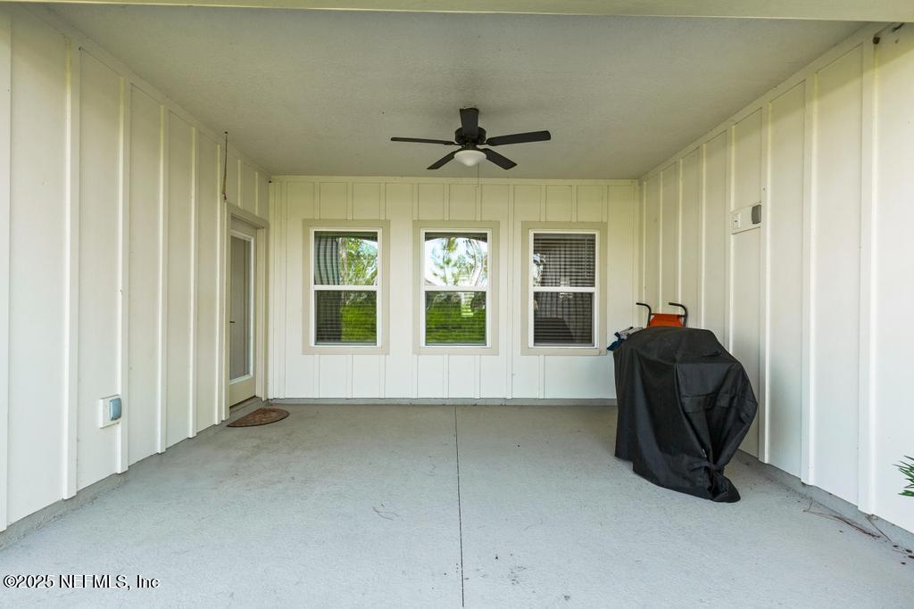 36012 Pitch Lane Hilliard, FL 32046 - Photo 41 of 54 a living room with a large window and chandelier