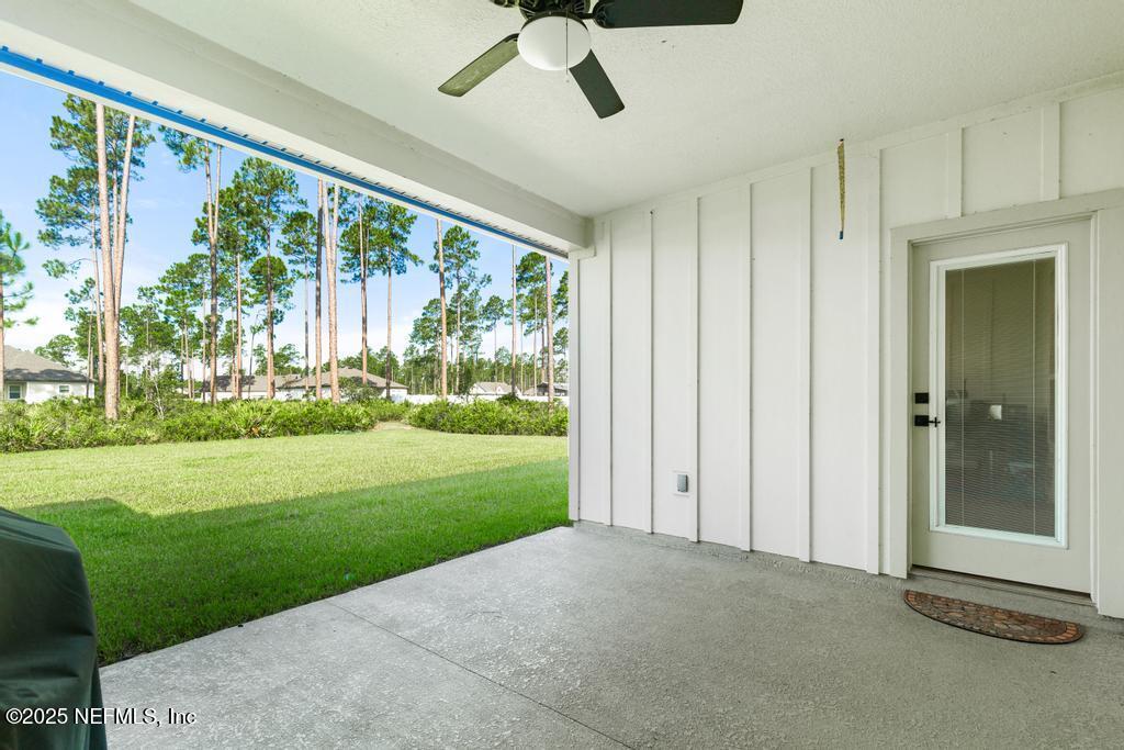 36012 Pitch Lane Hilliard, FL 32046 - Photo 42 of 54 a view of a room with a big yard and front door
