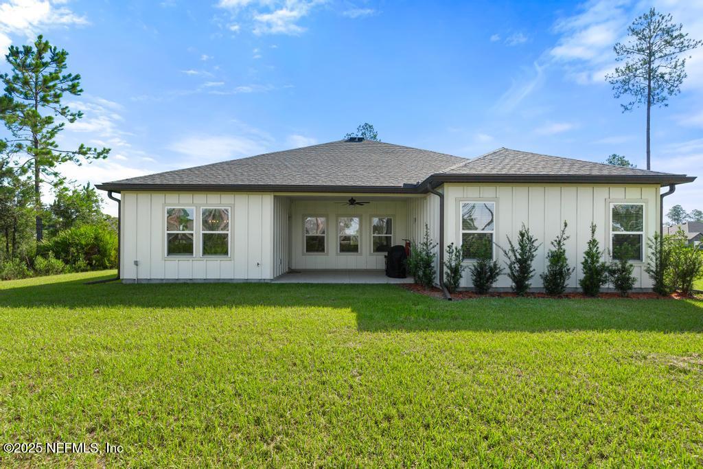 36012 Pitch Lane Hilliard, FL 32046 - Photo 44 of 54 a front view of a house with a garden