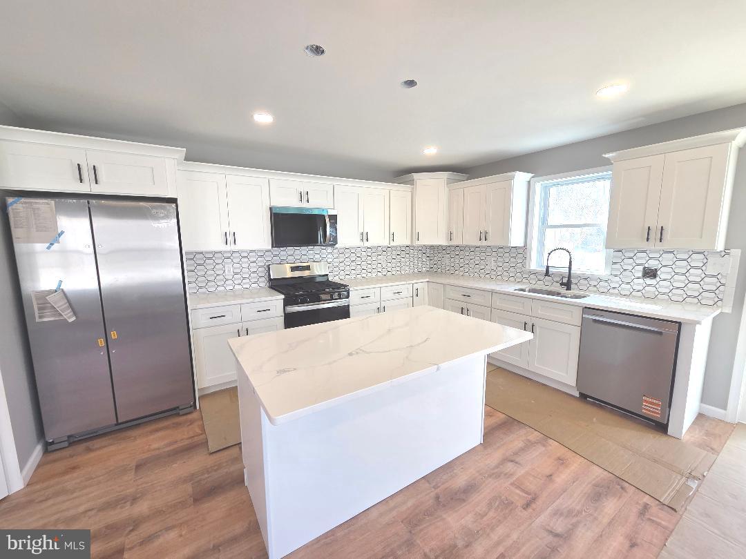 730 Excelsior Avenue Croydon, PA 19021 - Photo 3 of 10 a kitchen with stainless steel appliances granite countertop a stove a sink a refrigerator and white cabinets