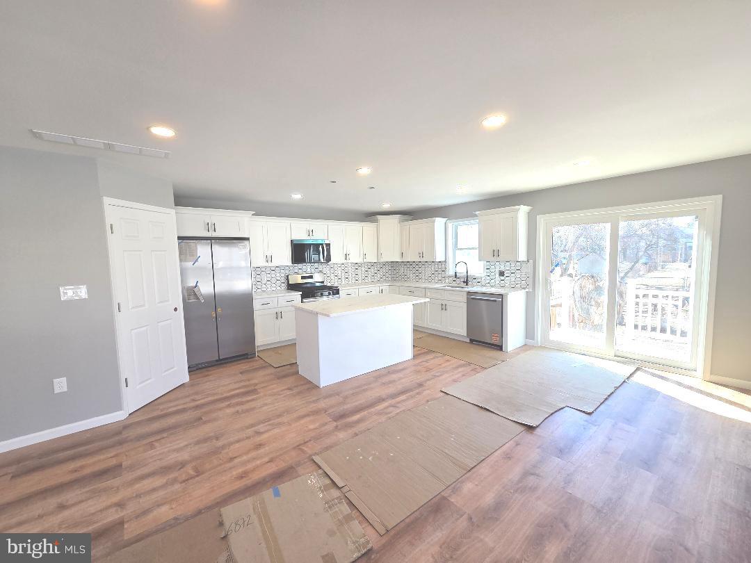 730 Excelsior Avenue Croydon, PA 19021 - Photo 4 of 10 a large white kitchen with a refrigerator a counter top space and stainless steel appliances